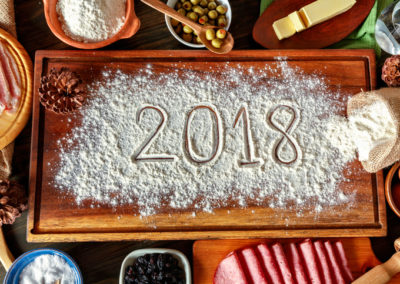 2018 new year's eve sign with Venezuelan Christmas food ingredients for jam bread or pan de jamon over cutting board